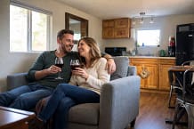 happy couple in living room at the Blue Pecker Perch