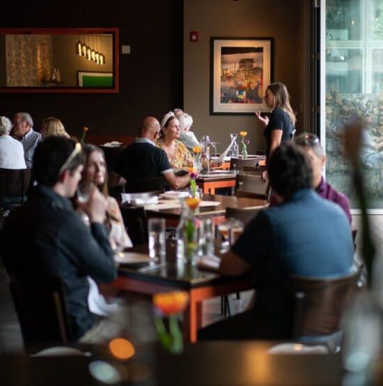 patrons and a server at Vin48 Restaurant