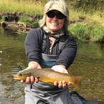 woman catching a trout