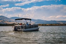 pontoon boat floating in the Boulder Reservoir in Boulder Colorado