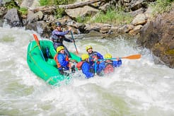 Colorado Rafting Company roaring through Class IV–V rapids on Clear Creek