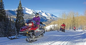 girl riding a snowmobile