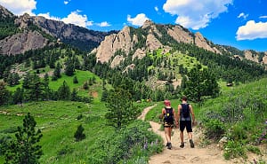 people hiking to the flatirons in boulder, co