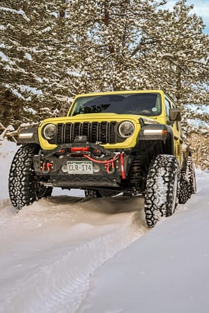 yellow jeep in snow